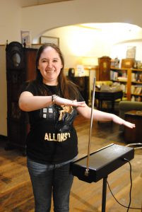 Amy Mulligan, a Doctor Who enthusiast and Spark Museum volunteer, demonstrates the theremin while wearing a Doctor Who t-shirt, highlighting the early electronic music technology that influenced the Doctor Who theme song.
