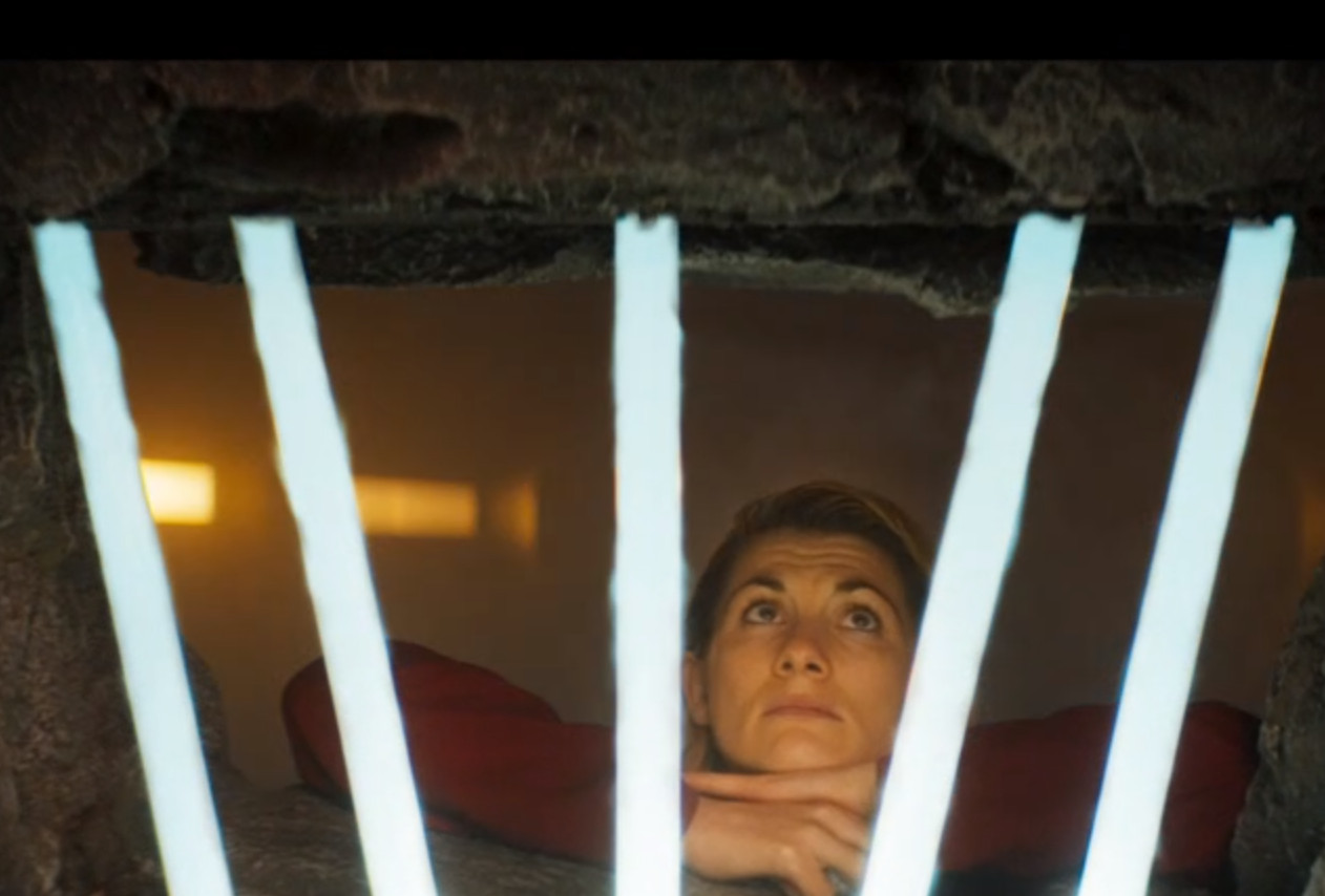 The Doctor in prison, marking tally marks on the wall, a humorous and poignant depiction of her isolation after the Timeless Children revelations.