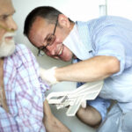 Doctor checking patient's pulse