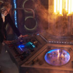 The Twelfth Doctor stands at the TARDIS console as he prepares to regenerate.