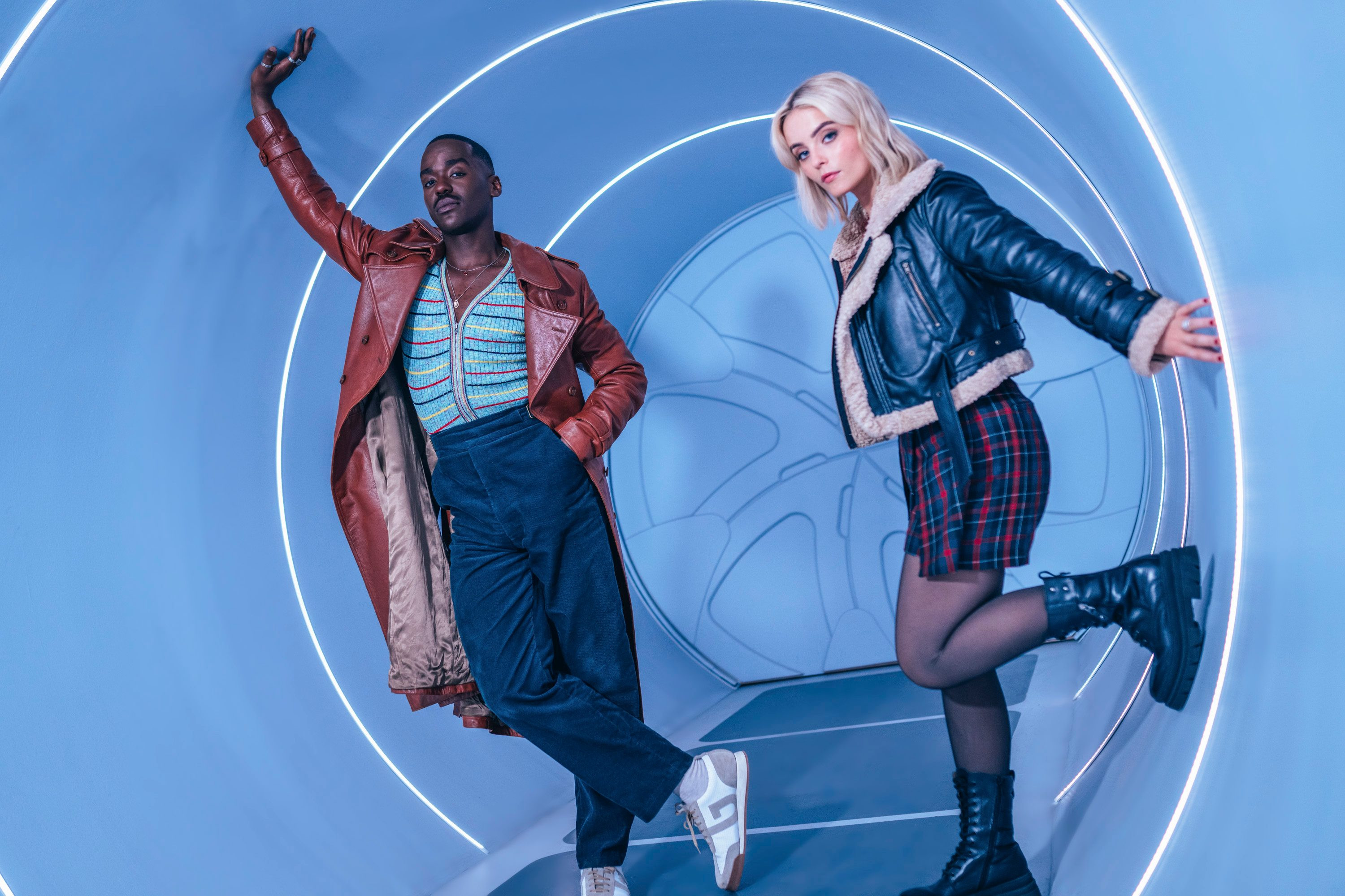 Ncuti Gatwa as the Doctor and Millie Gibson as Ruby Sunday in Doctor Who leaning against a silver wall