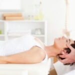 chiropractor adjusts patients back