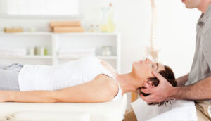 chiropractor adjusts patients back
